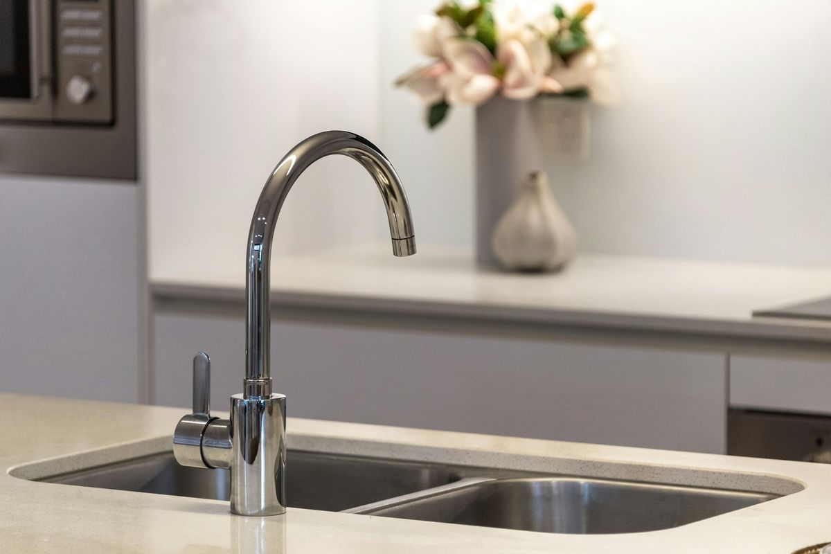 Stainless steel kitchen faucet over a double sink